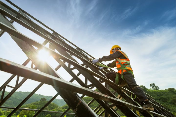 Roof worker installing steel roof