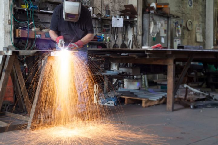 Worker cutting stainless steel